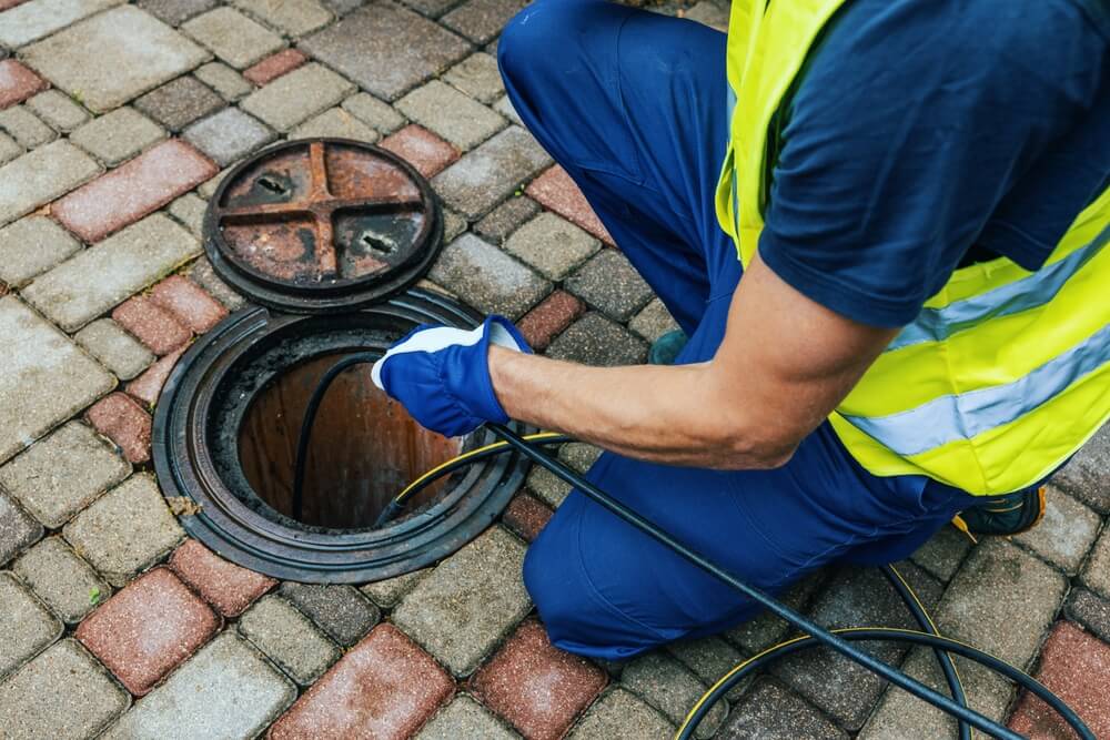 Workman Cleaning Blocked Pipes